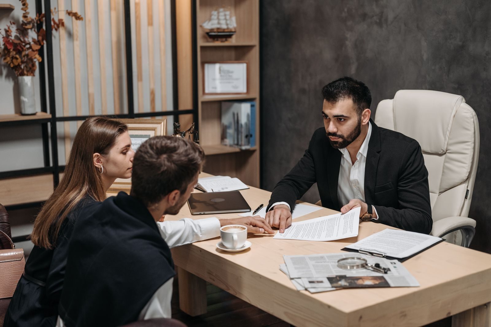 An adviser going through documents with clients at his desk